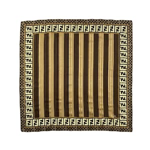 May include: A square silk scarf with vertical stripes in shades of brown and tan. The scarf has a border with a repeating logo pattern in black and cream. The scarf is a luxury fashion accessory.