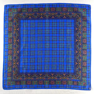 May include: A square blue handkerchief with a plaid pattern. The centre features a bright blue plaid design, framed by a decorative border with ornate floral and geometric elements in shades of green, gold, and purple. The edges are a solid blue.