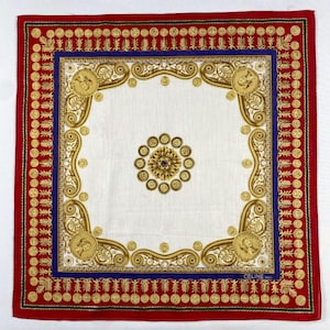 May include: Square silk scarf with a white centre, framed by a blue border and a red outer edge. The design features gold-coloured decorative elements, including coins and ornate scrollwork. The brand name "CELINE" is visible.