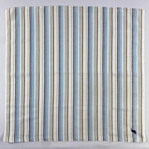 May include: A square handkerchief with vertical stripes in white, blue, and brown. The stripes vary in width, creating a classic design. A small, dark blue embroidered logo is in the bottom right corner. The fabric appears to be cotton or a similar material.