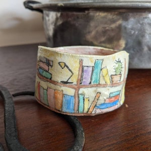 Clay bangle bracelet featuring a hand painted bookcase scene, wearable whimsical clay art image 1