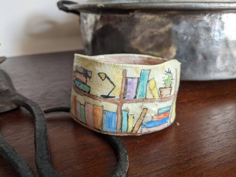 Clay bangle bracelet featuring a hand painted bookcase scene, wearable whimsical clay art image 1