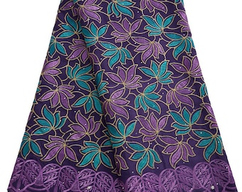 May include: Purple and teal floral lace fabric with a scalloped edge.