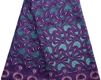 May include: Purple and teal lace fabric with a floral pattern. The lace has a scalloped edge.