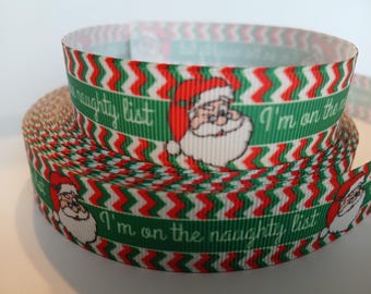 May include: A roll of festive ribbon with a green background and red and white zig-zag design. The ribbon displays Santa Claus images and the text "I'm on the naughty list" in white.