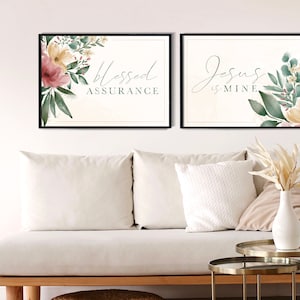 May include: Two framed prints with floral designs and inspirational quotes. The left print features a watercolour floral design with the text "Blessed Assurance". The right print features a watercolour floral design with the text "Jesus is Mine".
