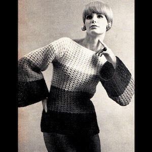 May include: A black, white, and gray striped sweater with bell sleeves. The sweater has a boat neck and is knitted in a textured stitch.