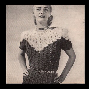 May include: A black and white photo of a woman wearing a crocheted dress with a white collar and a black belt. The dress has a scalloped neckline and short sleeves.