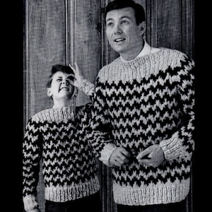 May include: Two people wearing black and white chevron patterned sweaters. The sweater on the left is a child's size and the sweater on the right is an adult size.
