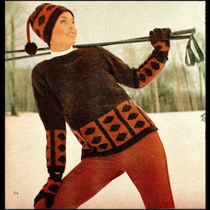 May include: A woman wearing a brown and orange knitted sweater with a geometric pattern. She is wearing a matching knitted hat with a pom-pom and gloves. She is holding ski poles.
