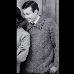 May include: A gray knitted sweater with a large collar and a button closure. The sweater has a textured knit pattern.