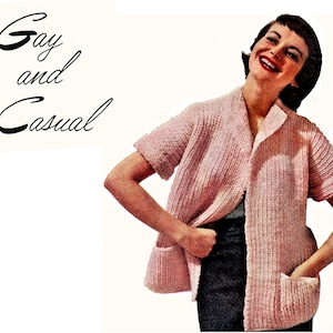May include: A vintage-style pink knitted cardigan with short sleeves and two front pockets. The cardigan is open in the front and has a collar. The words "Gay and Casual" are written in black script in the upper left corner.