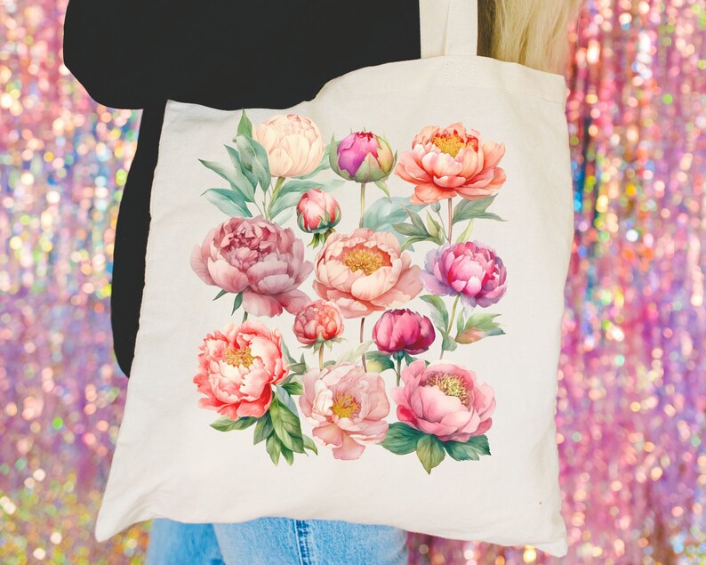 May include: A white tote bag with a floral design featuring pink, peach, and white peonies. The flowers are arranged in a cluster and have green leaves.