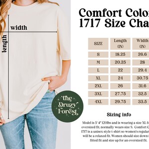 May include: Cream-colored t-shirt with a size chart for Comfort Colors 1717. The chart lists sizes S to 4XL, with length and width measurements in inches. The text "the Druzy Forest" is on a green circular logo.