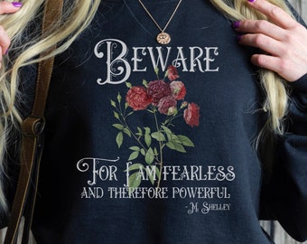 May include: Black sweatshirt with a floral design and the text "Beware for I am fearless and therefore powerful - M. Shelley".