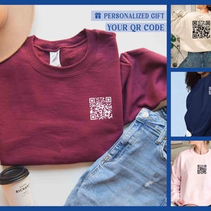 May include: Three sweatshirts in different colors, maroon, navy blue, and pink, with a white QR code design on the front.  The text "Personalized Gift Your QR Code" is at the top of the image.