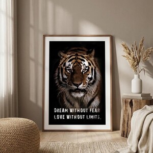 May include: Framed art print featuring a close-up of a tiger's face with a black background. The tiger has brown and black stripes. White text reads "DREAM WITHOUT FEAR LOVE WITHOUT LIMITS."