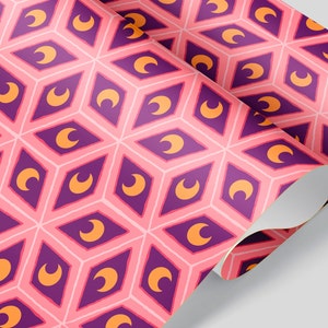 May include: Pink and white patterned wallpaper with a repeating geometric design. The pattern features purple diamond shapes with orange crescent moons inside. The wallpaper is rolled up, showing the pattern on the surface.