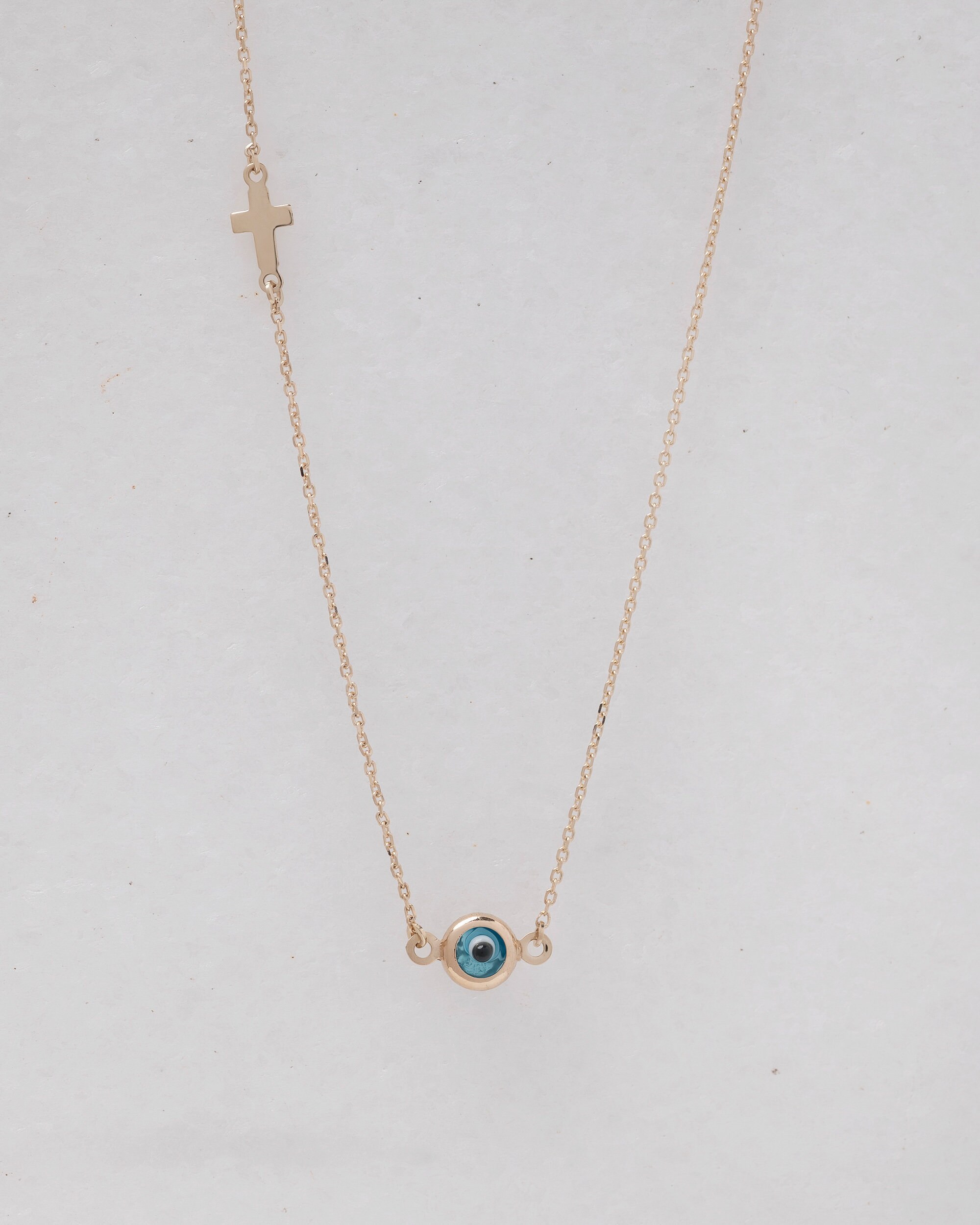Evil Eye and Cross Necklace in 14 Karat Gold.