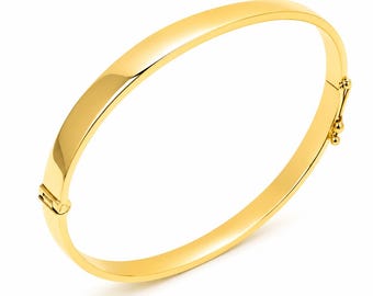 May include: A polished yellow gold bangle bracelet with a smooth, curved surface and a hinged clasp mechanism. The bracelet features a continuous, solid band design that maintains a consistent width throughout, showcasing a reflective metallic finish.