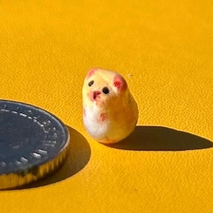 Könnte beinhalten: Ein Set aus drei Keramikbechern mit gesprenkelter, matter Oberfläche. Die Becher sind in Creme-, Hellgrau- und Dunkelgrautönen gehalten. Jeder Becher hat ein schlichtes, minimalistisches Design und einen abgerundeten Henkel.