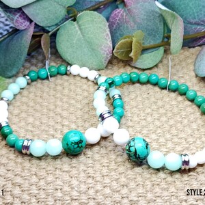 May include: Two beaded bracelets with turquoise, white, and light blue beads. The bracelets have silver-colored spacers and a large turquoise bead. The text "STYLE 1" and "STYLE 2" are at the bottom of the image.