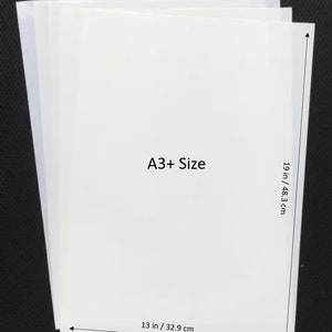 May include: A stack of white A3+ size paper, measuring 13 inches by 19 inches, or 32.9 cm by 48.3 cm.