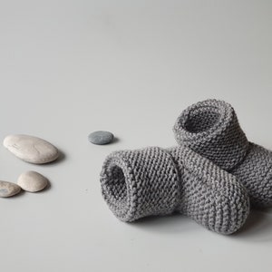 Children slippers from merino wool in dark grey color, which in the picture is in nice harmony with sea stones - perfect for minimalist style. Very comfy - no buttons, no ties, just wear on and go.