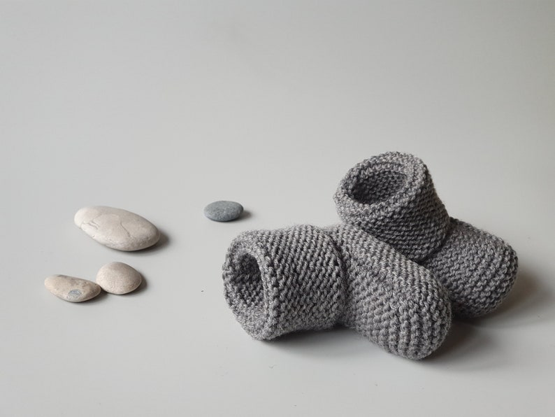 Children slippers from merino wool in dark grey color, which in the picture is in nice harmony with sea stones - perfect for minimalist style. Very comfy - no buttons, no ties, just wear on and go.
