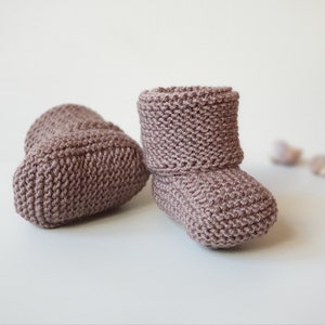 Children slippers with cuffs hand knitted in stretchy garter stitch. Warm and cozy from Oeko-tex certified pure merino wool. Very soft and specially suited for delicate baby skin. Available in sizes from newborn to toddler.