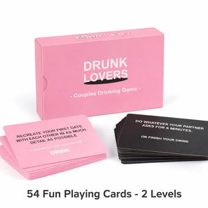 May include: A pink box set of the "Drunk Lovers" couples drinking game, with a stack of pink cards and a stack of black cards. The box and cards have white text. The pink cards have the word "DRINK" on them.