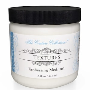 May include: A white plastic jar with a black lid containing a white embossing medium. The label reads "The Couture Collection!" "TEXTURES" "Embossing Medium" "16 fl. oz / 473 ml".