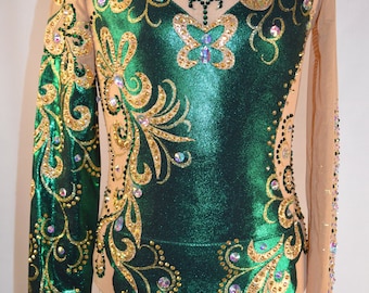 May include: A green leotard with gold and crystal embellishments. The leotard has a long sleeve and a scalloped bottom.