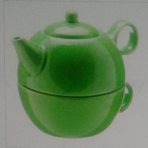 May include: A green ceramic teapot with a round body and a lid. The teapot has a handle on the side and a spout on the front.