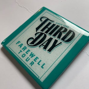 May include: Teal square coaster with a white background and black text that reads "Third Day" in a stylized font. The text "Since 1992" is above the band name and "Farewell Tour" is below the band name.