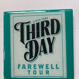 May include: A teal blue square coaster with a white rectangle in the center. The rectangle has black text that reads "Since 1992 Third Day Farewell Tour".