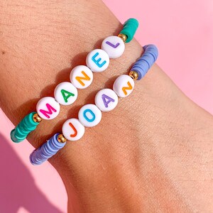 Customizable bracelets with colored letters and golden stainless steel and polymer clay beads with slider closure