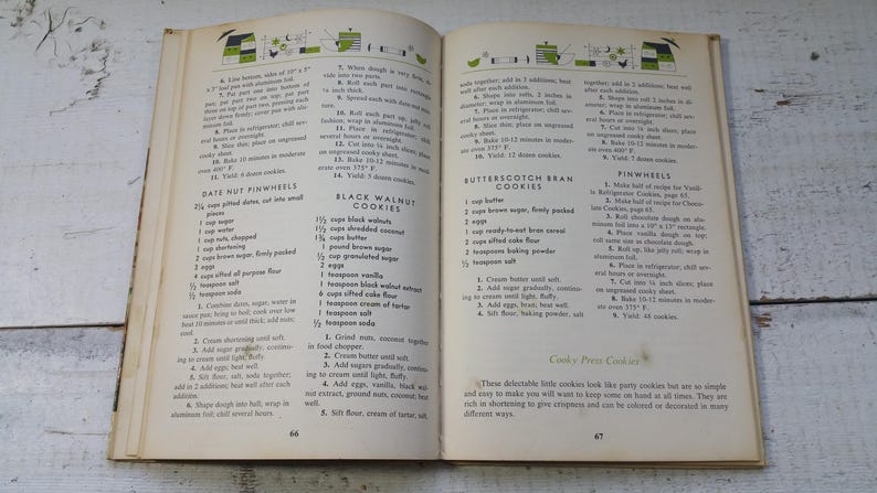May include: An open vintage cookbook displaying pages 66 and 67 with black text on off-white paper. The pages feature recipes for Date Nut Pinwheels, Black Walnut Cookies, and Butterscotch Bran Cookies, including ingredient lists and instructions.