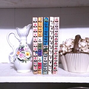 May include: A set of six vintage cookbooks with colorful covers and gold lettering. The titles are "Boys and Girls", "Cooking for Two", "Dinner for Two", "It's So Quick", "Guide to Easy Entertaining", and "Golden Press".