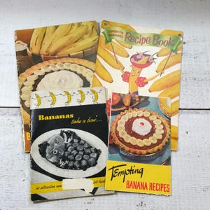 May include: Four vintage banana recipe books with yellow covers and colorful illustrations. The books feature titles like "Chiquita Banana's Recipe Book" and "Tempting Banana Recipes".