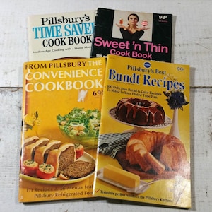 May include: A collection of vintage cookbooks with colorful covers. Titles include "Pillsbury's Time Saver Cook Book", "Sweet 'n Thin Cook Book", "From Pillsbury the Convenience Cookbook", and "Pillsbury's Best Bundt Recipes". The books feature images of food.