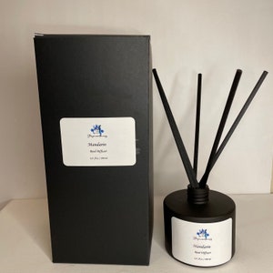 May include: A black box with a white label that says "Mandarin Reed Diffuser 6.8 fl oz / 200 ml" and a black bottle with a white label that says "Mandarin Reed Diffuser 6.8 fl oz / 200 ml" and black reeds.