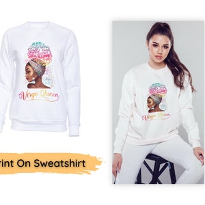 May include: White sweatshirt featuring a graphic of a woman with a colorful head wrap and the text "Virgo Queen." The graphic includes words like "graceful" and "alluring." The sweatshirt is shown on a model.