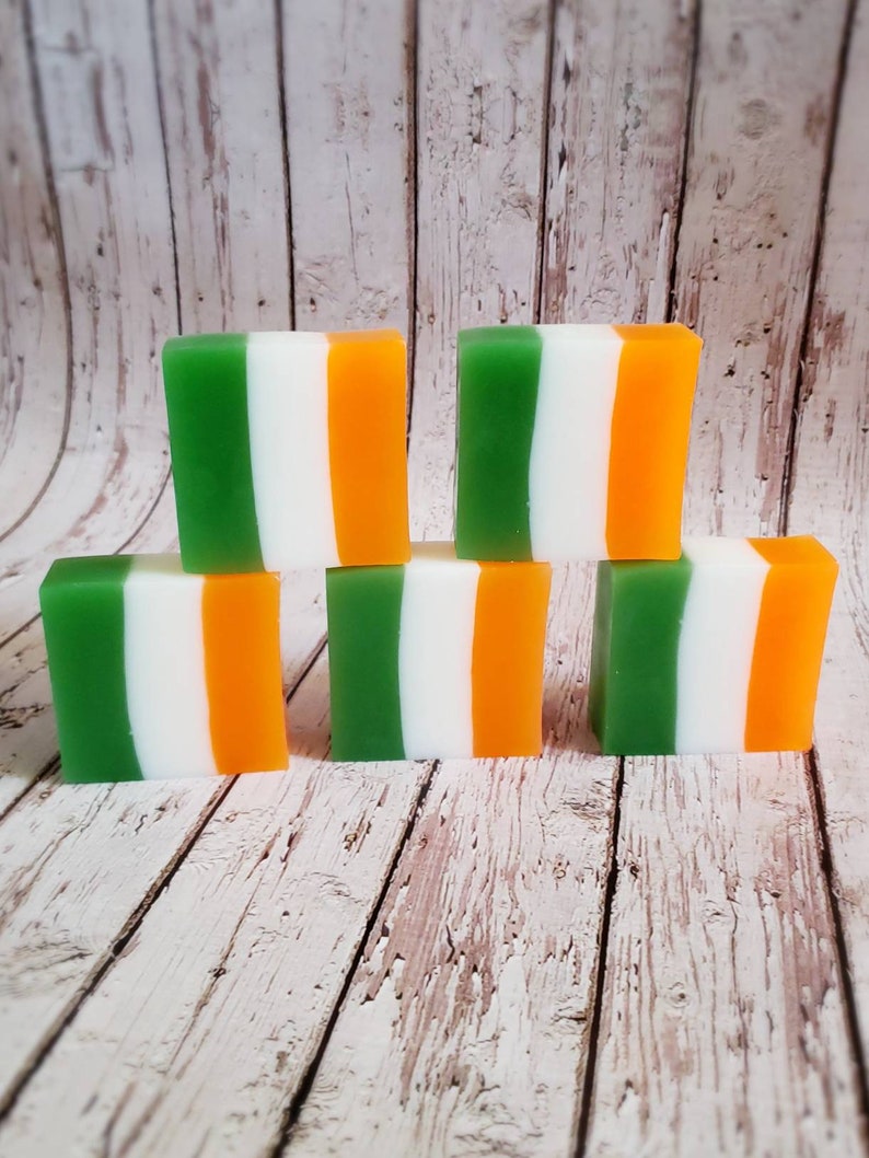 May include: Six bars of soap with green, white and orange stripes. The bars are arranged in two rows of three.