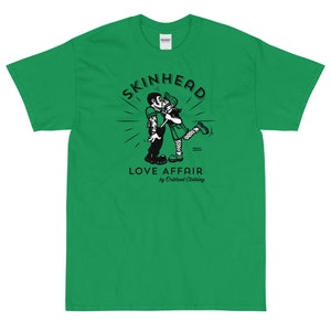 May include: Green t-shirt with a black and white illustration of a couple kissing. The illustration is surrounded by a circle with the text "SKINHEAD LOVE AFFAIR by Orblood Clothing".