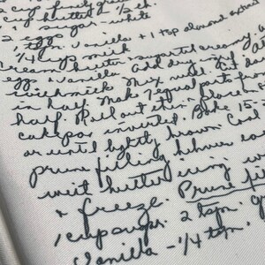 May include: Handwritten recipe for a cake with instructions for making the cake and filling. The recipe includes ingredients such as flour, sugar, eggs, vanilla, and almond extract. The recipe also includes instructions for freezing the cake and filling.