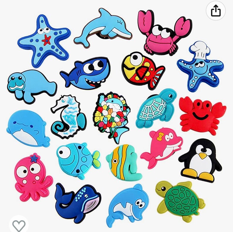 May include: A set of 18 colorful cartoon sea creature shoe charms. The charms include a blue whale, a pink dolphin, a red crab, a green turtle, a blue starfish, a yellow fish, a blue and white fish, a green and yellow fish, a blue and white seahorse, a pink octopus, a blue shark, a penguin, a blue manatee, a red crab, a green and yellow turtle, a blue starfish, a yellow fish, and a blue and white flower.