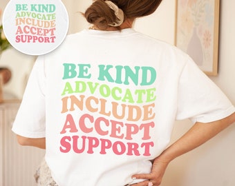 May include: White t-shirt with a rainbow colored graphic that says "Be Kind, Advocate, Include, Accept, Support".