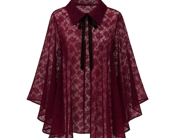 May include: A deep burgundy lace cape featuring a pointed collar and a dark ribbon tie at the neckline. The garment is crafted from a sheer, floral-patterned lace fabric with a flared, flowing silhouette that drapes from the shoulders.