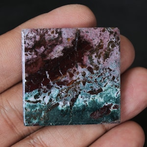 May include: A square, polished, green, purple, and brown stone with a mottled pattern.